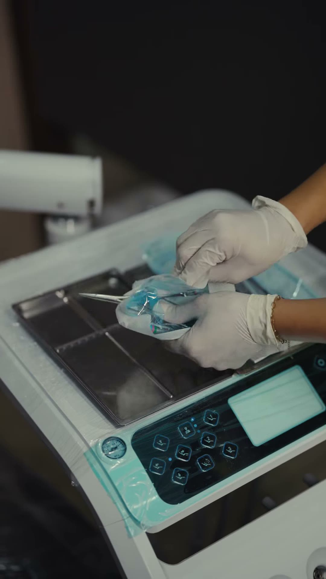Sealed sterile instrument pouches being opened at the autoclave